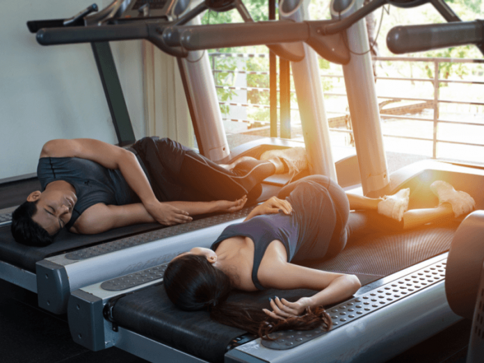 two people sleeping on a treadmill