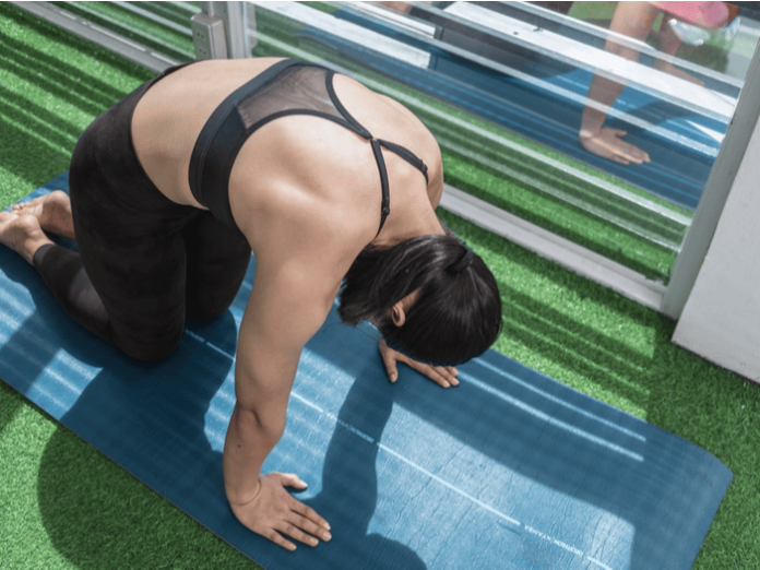 woman stretching back after workout