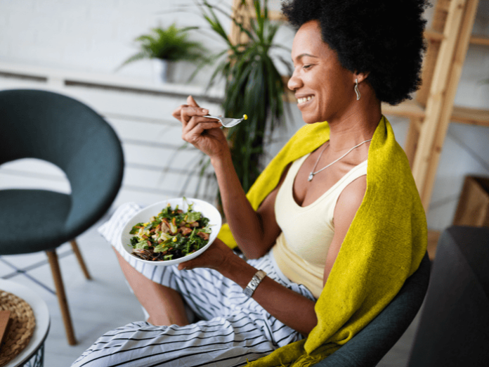 Woman eating vegetables