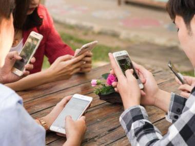 image of people addicted to their phones, causing social anxiety