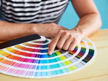 a hand choosing colors from color swatches