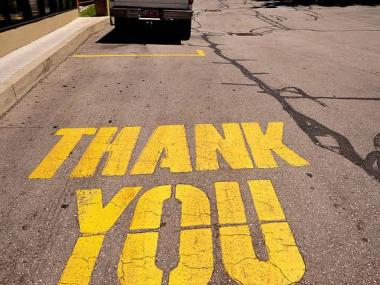 The words thank you painted on a street