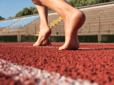 Photo of bare feet on a running track