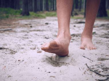 Photo of feet walking on sand