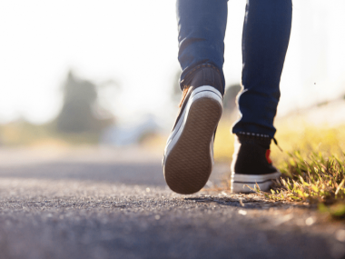 a person walking in park,depicting health benefits of walking