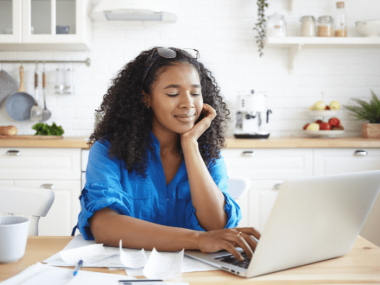 woman smiling slightly while working with receipts