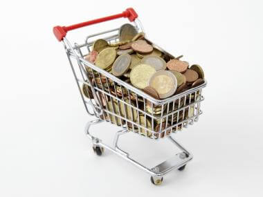 Coins in a grocery cart,representing saving money on groceries
