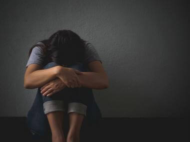 sad person against wall 