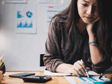 young woman calculating self-employment taxes