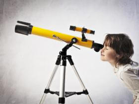 A boy looking stars from telescope