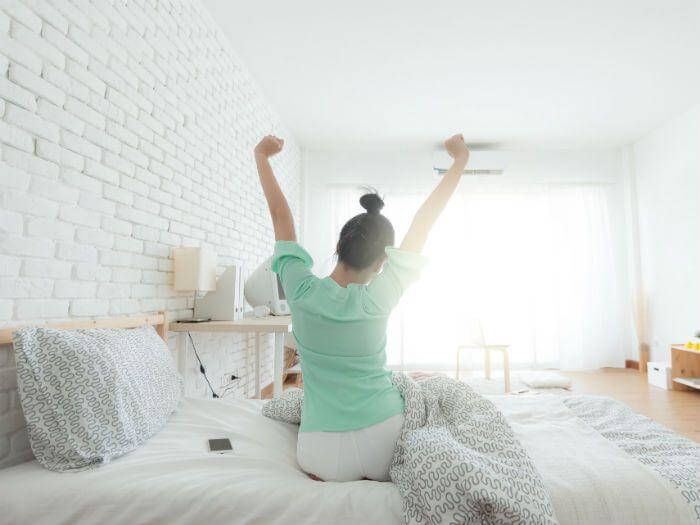 woman waking up refreshed