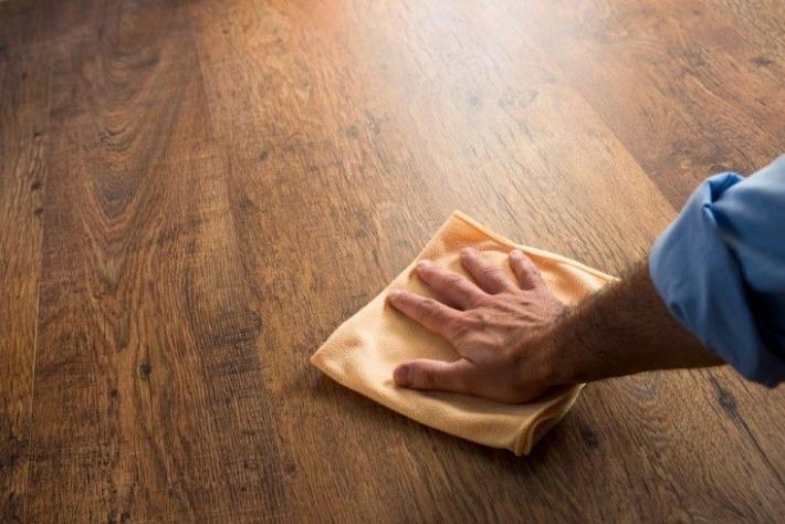 image of man cleaning floor with rag