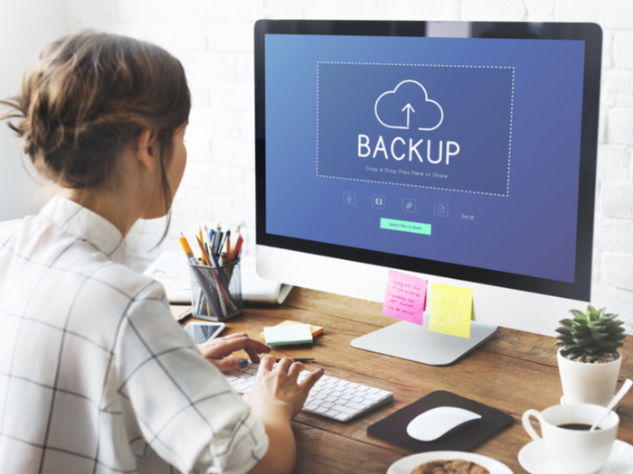 Woman backing up computer files.