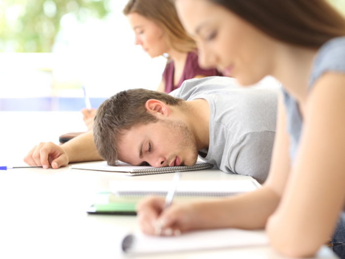 Student sleeping in college class.