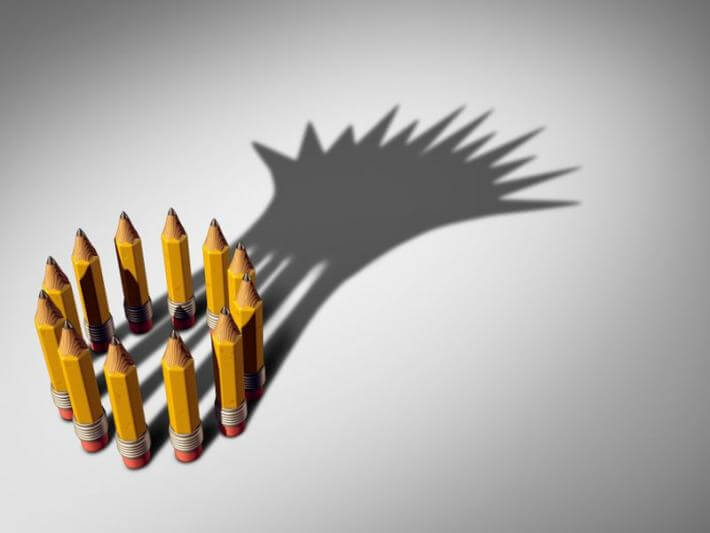 a circle of pencils making a shadow crown