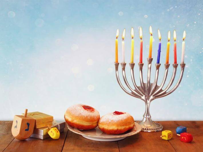 a menorah and other symbols of Hanukkah