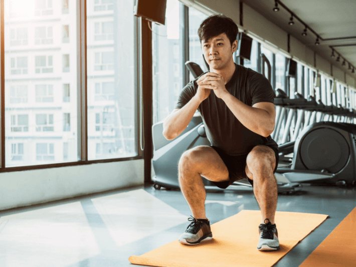 Photo of a man doing a squat