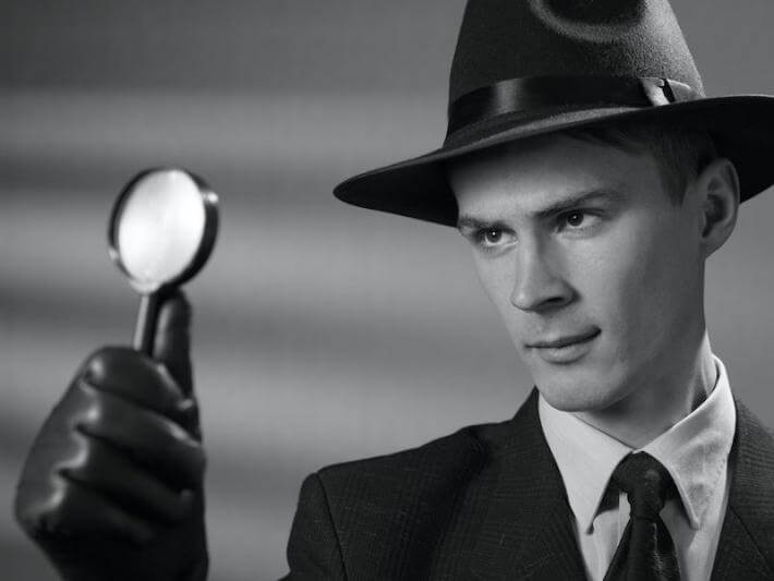 This is a picture of a detective looking for a clue with a magnifying glass
