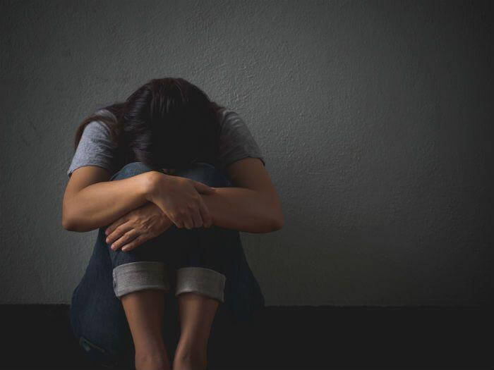 sad person against wall