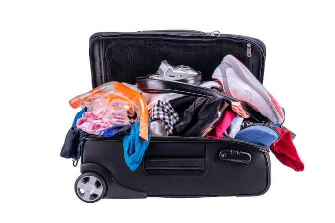 a dumped suitcase to illustrate unpacking lock, stock, and barrel at the airport
