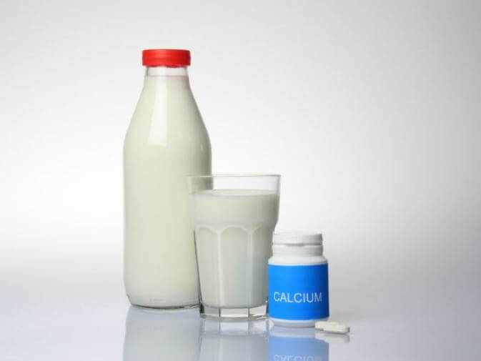 image of calcium pills and milk raising question of link between supplements and colon cancer