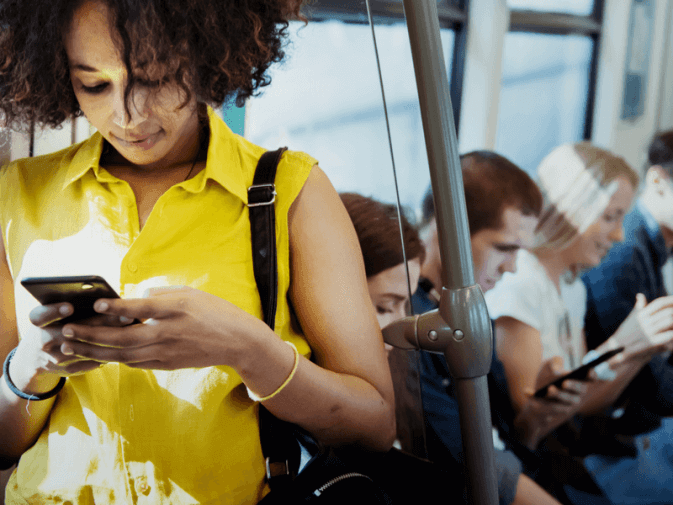 Photo of a woman being active on the subway