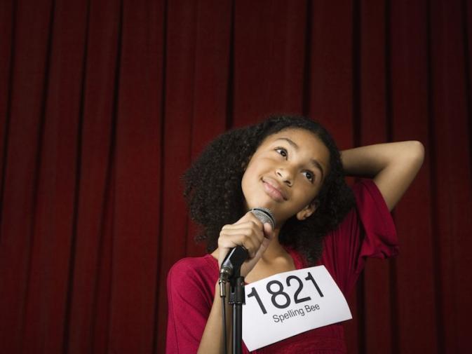 A picture of a little girl at a spelling bee