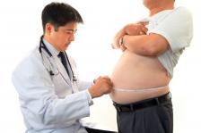 Doctor measuring a patient's waist