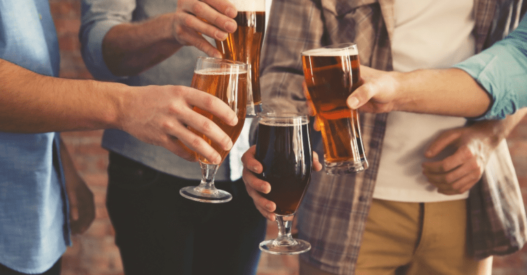 group of friends clinking alcoholic beverages