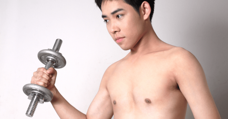 a skinny guy holding a dumbbell