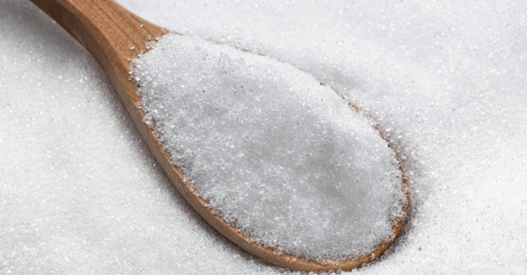 erythritol or sweeteners in a big pile with a wooden spoon scooping it