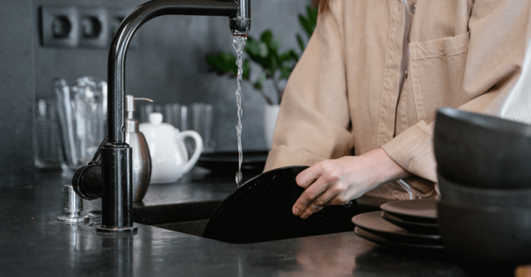 woman washing pans and dishes