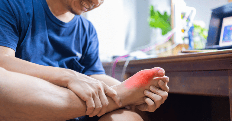 a man holding his foot in pain