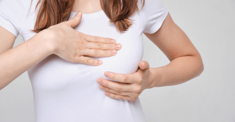 a woman feeling pain in her breast