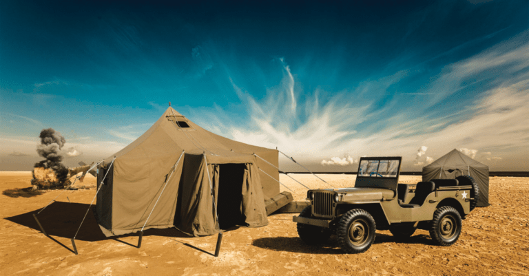 tent and a jeep out in the desert