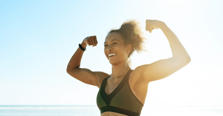 a person smiling and flexing their arm muscles