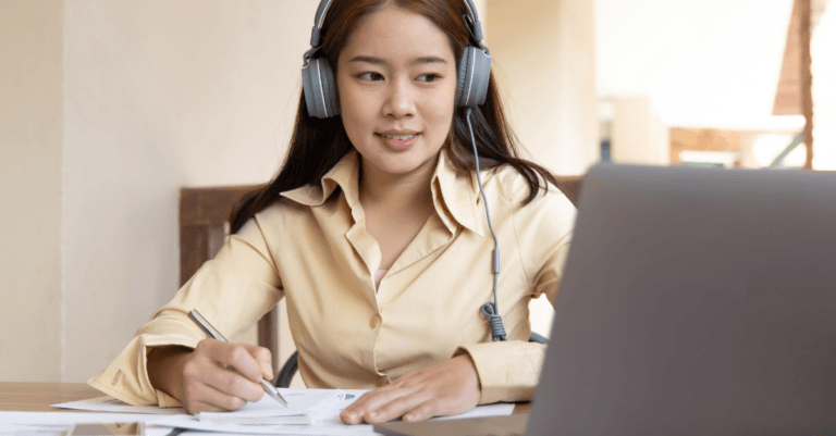girl studying at her computer with headphones on