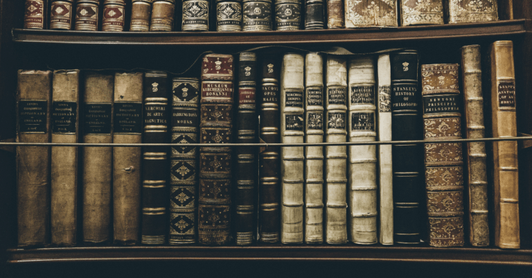 a bunch of old books on bookshelves