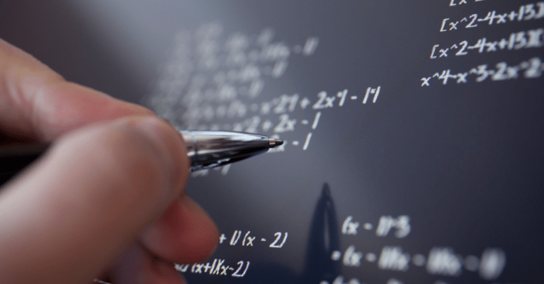 a person writing math equations on a board or tablet