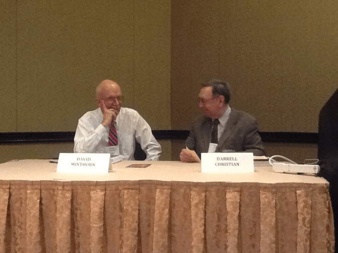 Two men sitting behind a conference table