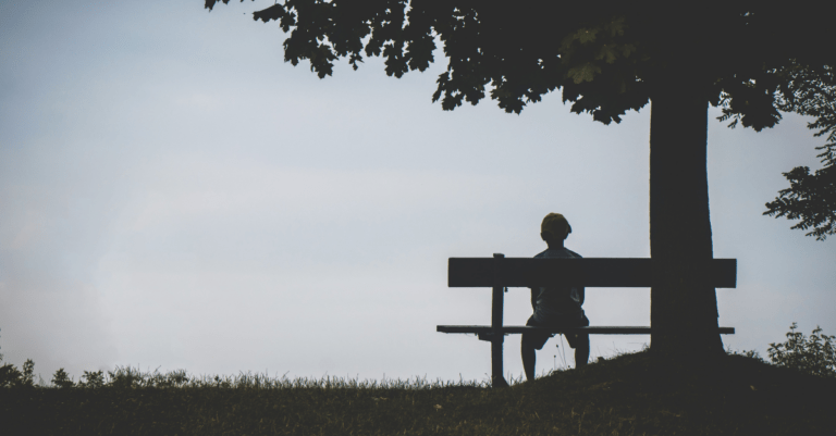 person sitting on a bench by themselves