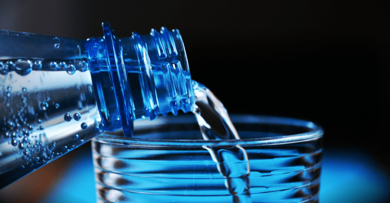 water being poured from a bottle into a glass