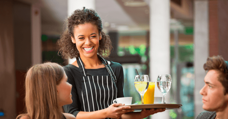 a waitress serving two customers