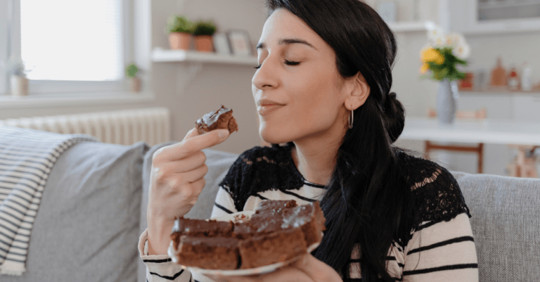 woman eating a whole plate of brownies