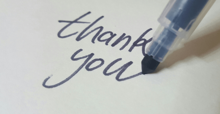 the words thank you written in blue marker