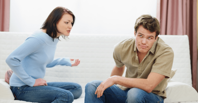 a couple sitting on a couch arguing