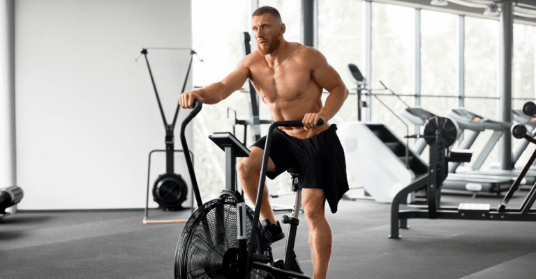 a main working out in the gym using a bike