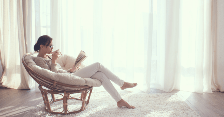 a woman relaxing in a chair near the window