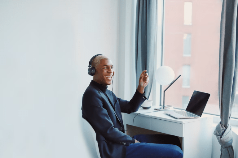 Person sitting at desk with headphones on