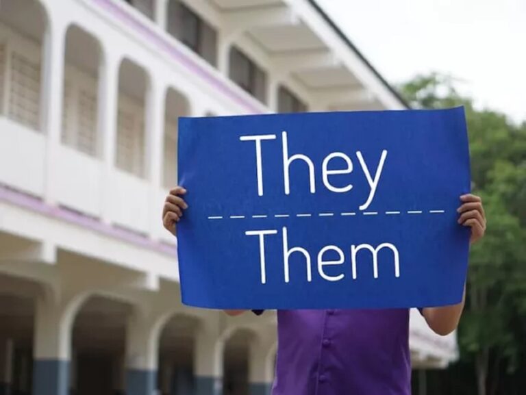 A blue sign that says "they, them."